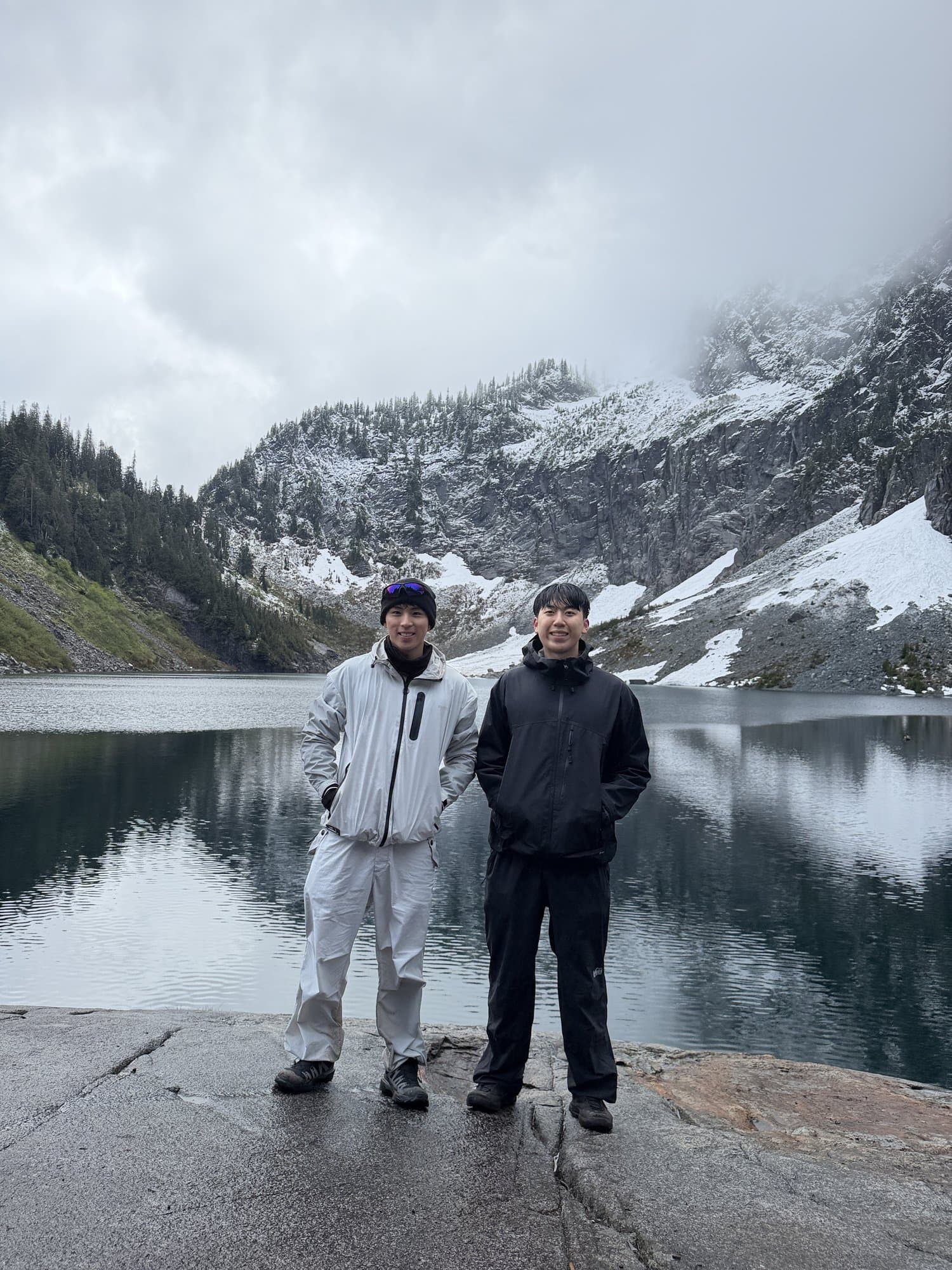 Two brothers at an alpine lake