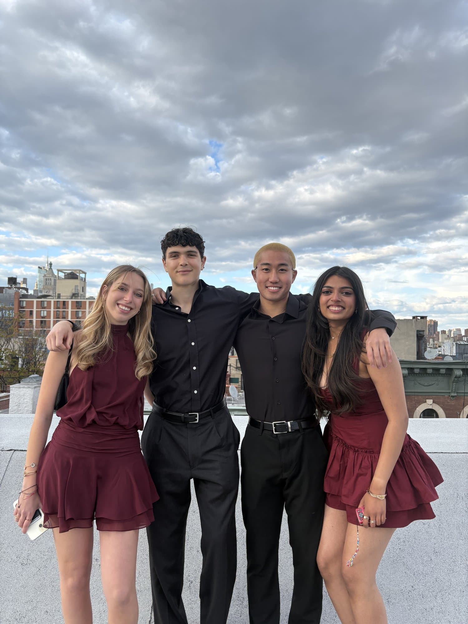 Four brothers on a rooftop before formal