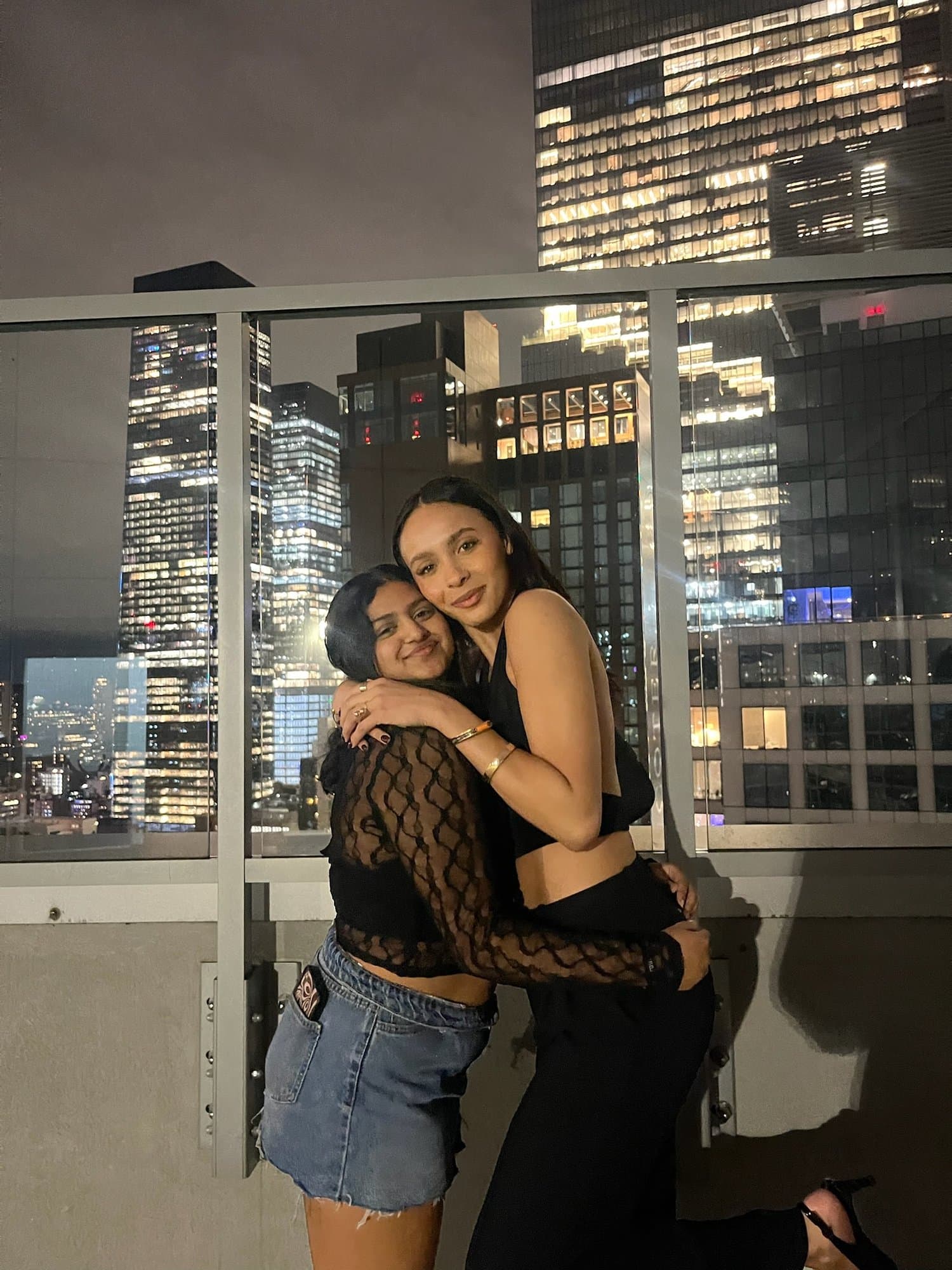Two brothers on a rooftop at night